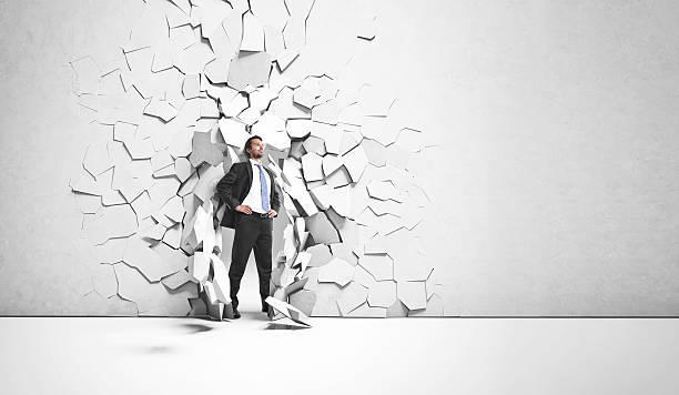 istock businessman breaks trough a wall 499191683