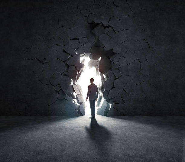 istock businessman breaks trough a wall 499191693