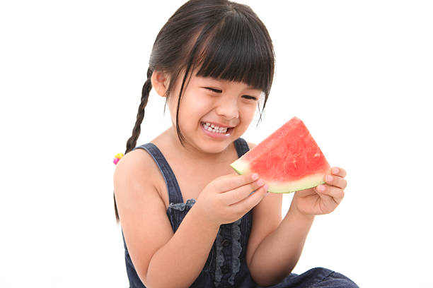 istock Little girl eating fruit - water melon 499192093