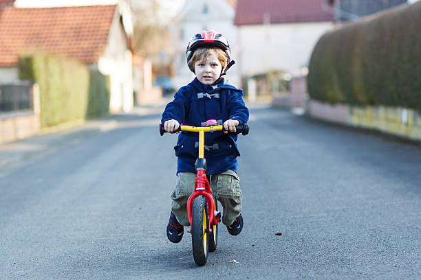 istock Little boy riding bicycle in village or city 499192521