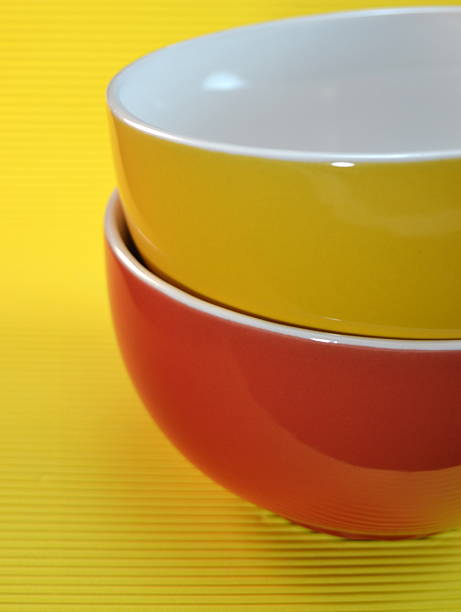 istock Yellow and red bowl on yellow background 499193027