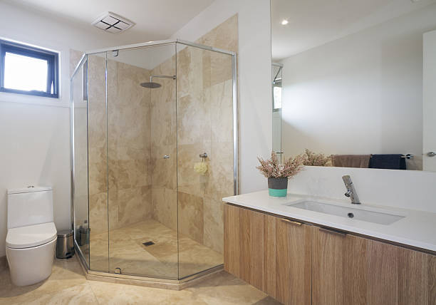 istock Corner shower marble tiling in contemporary bathroom 499196394