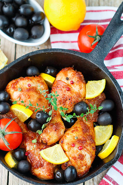 istock Fried chicken. Fried chicken legs with lemon and olives 499197718