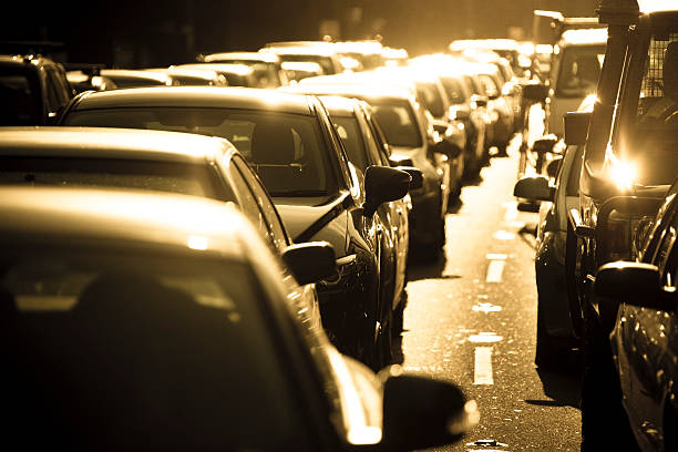 It’s hot in a Sydney summer rush hour traffic jam It’s hot in a Sydney summer rush hour traffic jam.  Gridlock on busy Sydney main road.  Looking up line of stationary vehicles into the setting sun.  Sunflare. Horizontal. heat haze stock pictures, royalty-free photos & images