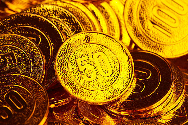 istock Golden coins piled in a heap of background 499200862