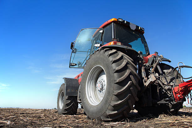 istock Tractor working in the field sunny day 499202980