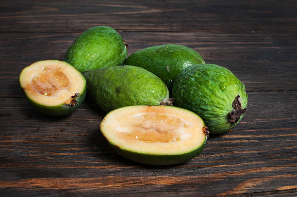 istock Feijoa on a dark wood background. toning. selective focus 499203448