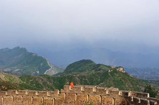 a lonely tourist on the Great Wall after rain.