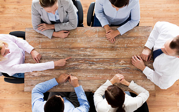 istock close up of business team sitting at table 499205546