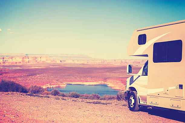 istock Vintage toned RV (camper) parked by canyon. 499205656