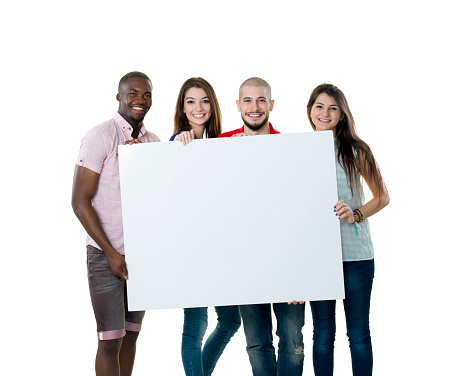 Four college students holding a blank sign isolated on a white background 