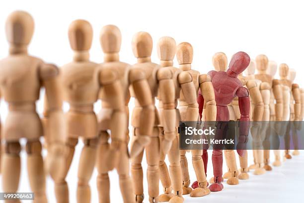Wooden Mannequin Looking Out Of The Row Stock Photo - Download Image Now - Waiting In Line, Artist's Figure, Mannequin