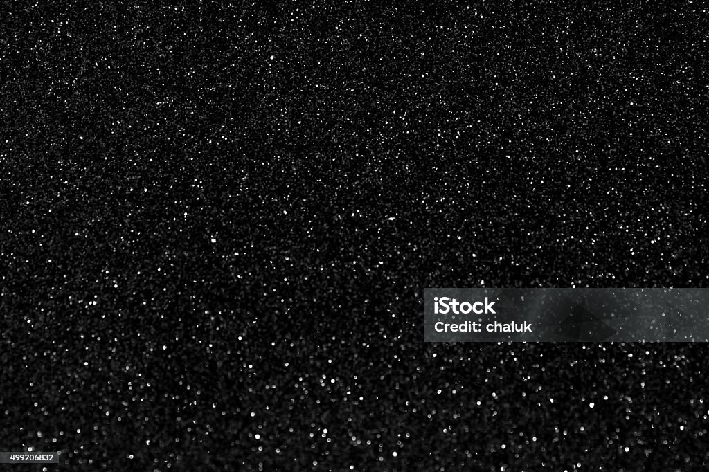 Glittering fashion black background Glittering fashion black background with twinkling grainy texture Black Color Stock Photo