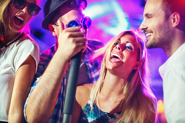 istock Group of people singing karaoke. 499206868
