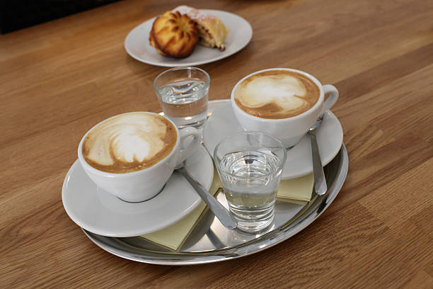 istock Glasses of coffee with water on tray 499207061