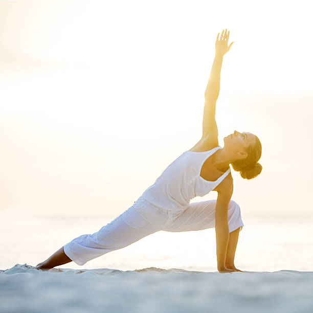 istock Caucasian woman practicing yoga at seashore 499207878
