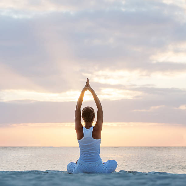 istock Caucasian woman practicing yoga at seashore 499208002