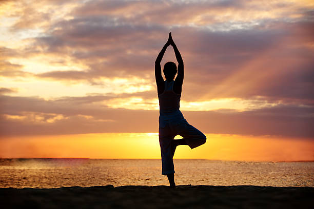 istock Caucasian woman practicing yoga at seashore 499208046