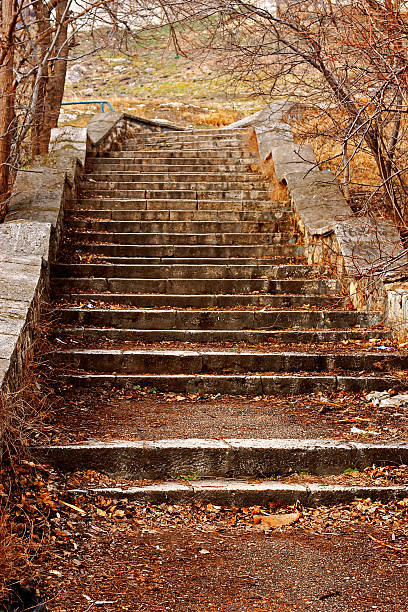 istock Old stone stairs leading up in autumn park 499208535