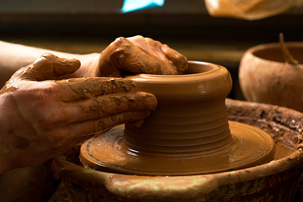istock hands of a potter, creating an earthen jar 499208835