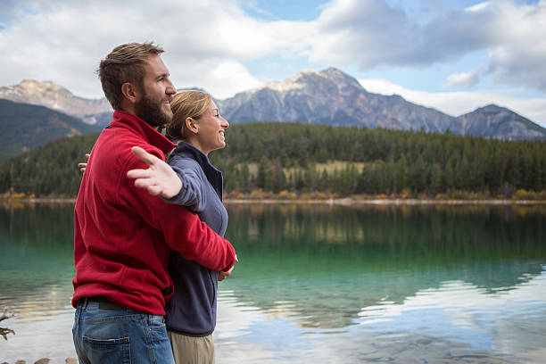 istock Young couple relaxing by the lake 499208988