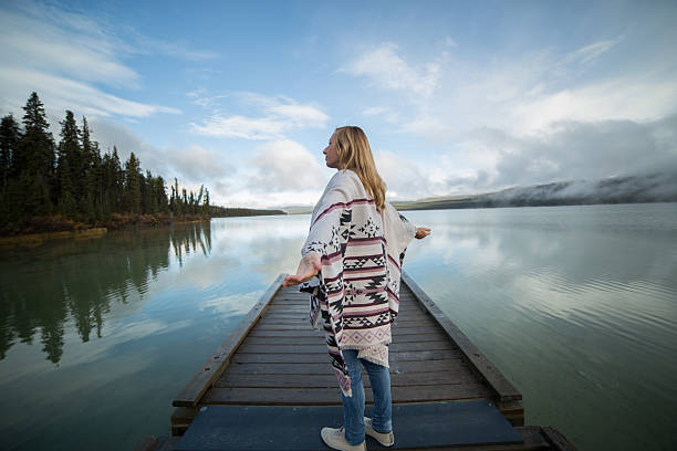 istock Young serene woman relaxing by the lake 499209214