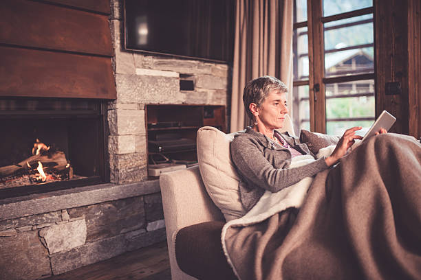 istock Senior Woman Reading on Sofa 499210448