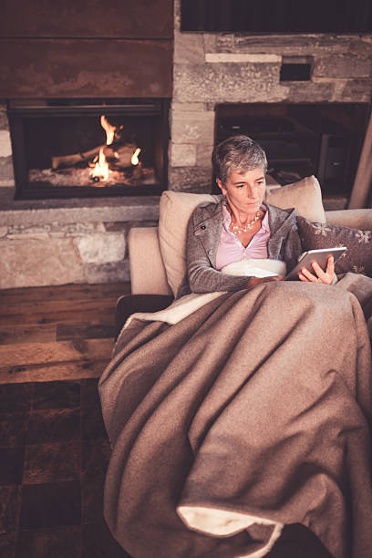 istock Senior Woman Reading on Sofa 499210504