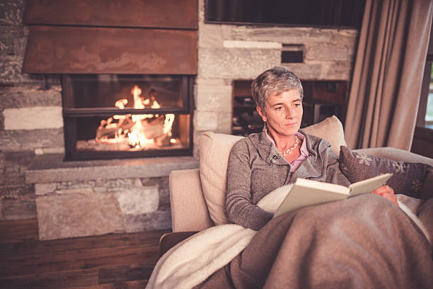istock Senior Woman Reading on Sofa 499210554