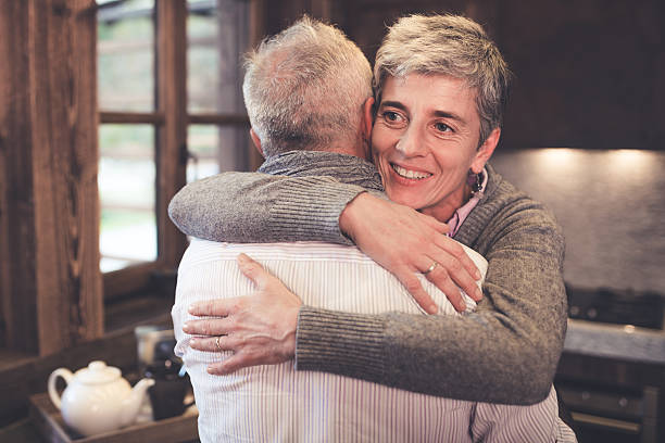 istock Senior couple embrace in kitchen 499210590