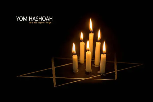 Six burning candles and the star of David against black background, text Yom Hashoah, the Jewish Holocaust and Heroism Remembrance Day