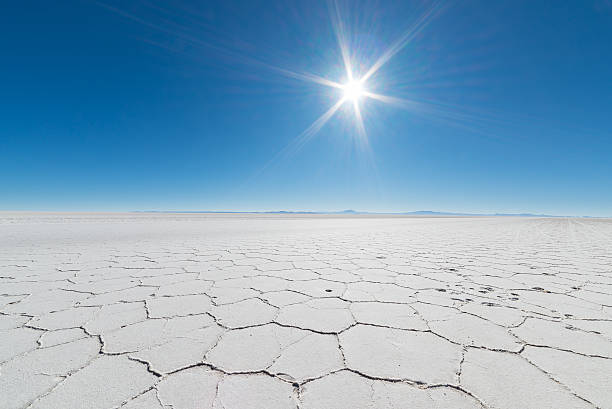 Backlight in the majestic Uyuni Salt Flat, Bolivia Wide angle view of the world famous Uyuni Salt Flat, among the most important travel destination in the Bolivian Andes. Close up of hexagonal shapes of the salt pans in backlight. salar de uyuni stock pictures, royalty-free photos & images