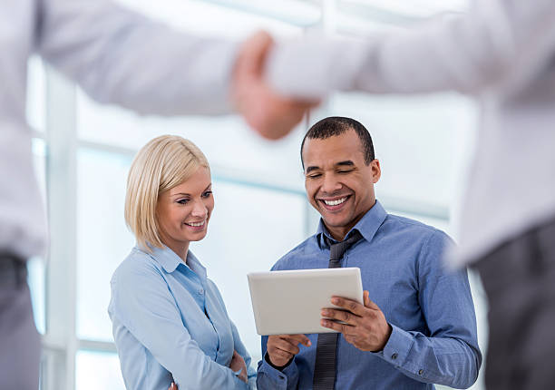 istock Happy business colleagues using digital tablet together. 499211738