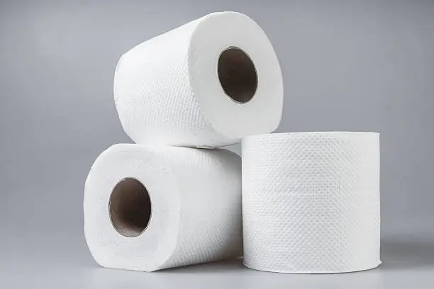 Photo of Stack of white tissue paper rolls.