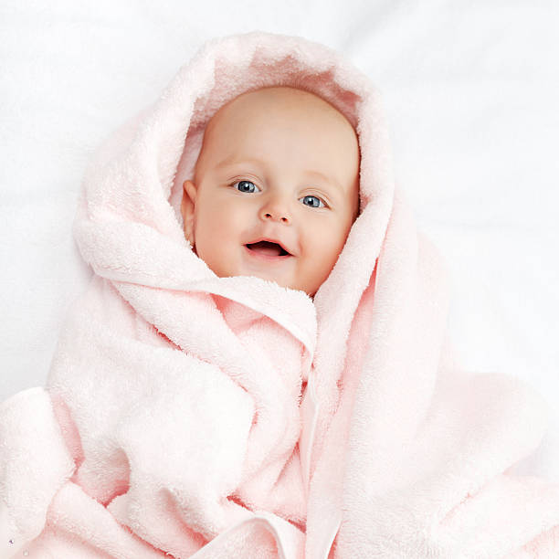 istock Caucasian baby boy covered with pink towel 499225258