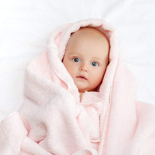 istock Caucasian baby boy covered with pink towel 499225284