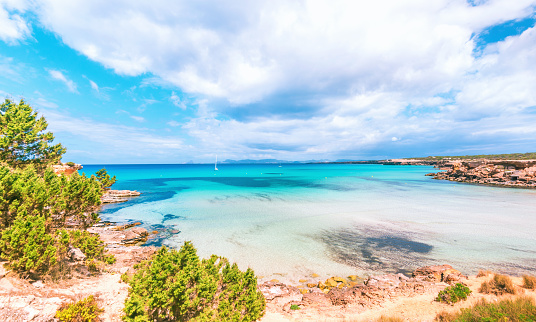 View over the beautiful bay and sailing boats at Cala Saona, Formentera.