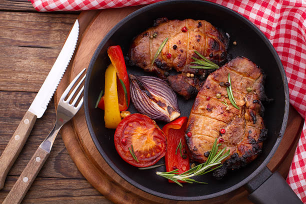 istock Food. Meat barbecue with vegetables on wooden surface. 499228337