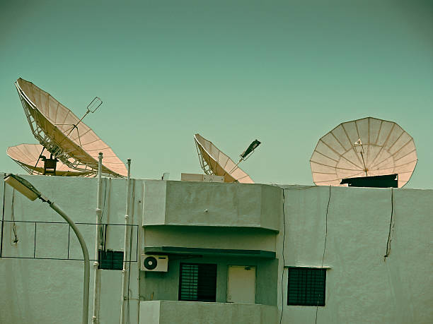 istock Dish antennas are fitted on terrace at different angles 499228342