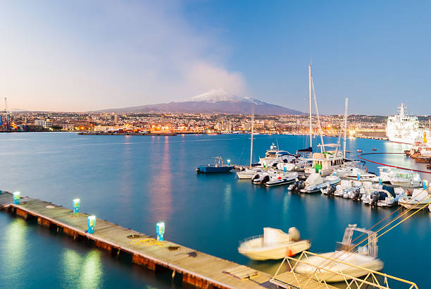 Skyline of Catania with volcano Etna after the sunset stock photo