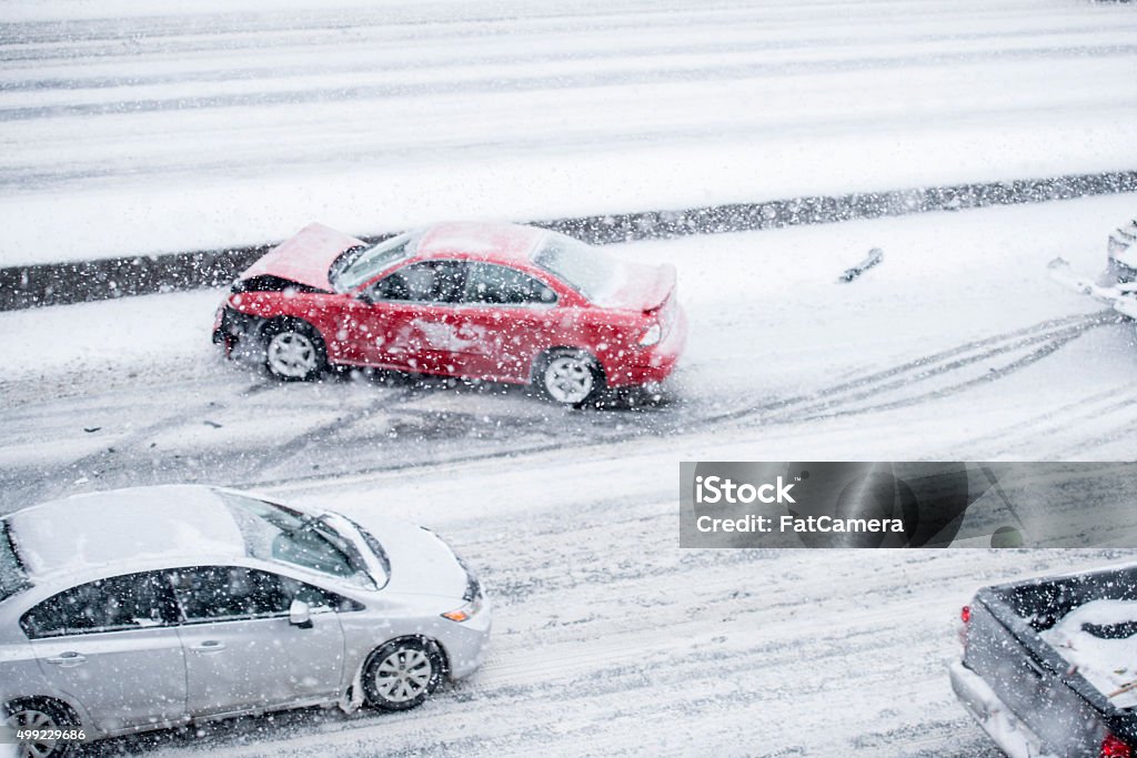 Car Accident on the Freeway A red car has slid on the icy road and his into the freeway medium. This has created a traffic jam for the other cars. Car Accident Stock Photo