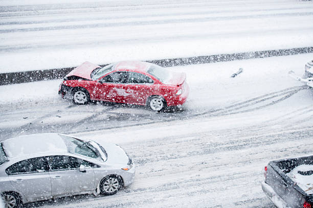 Car Accident on the Freeway A red car has slid on the icy road and his into the freeway medium. This has created a traffic jam for the other cars. car snow stock pictures, royalty-free photos & images