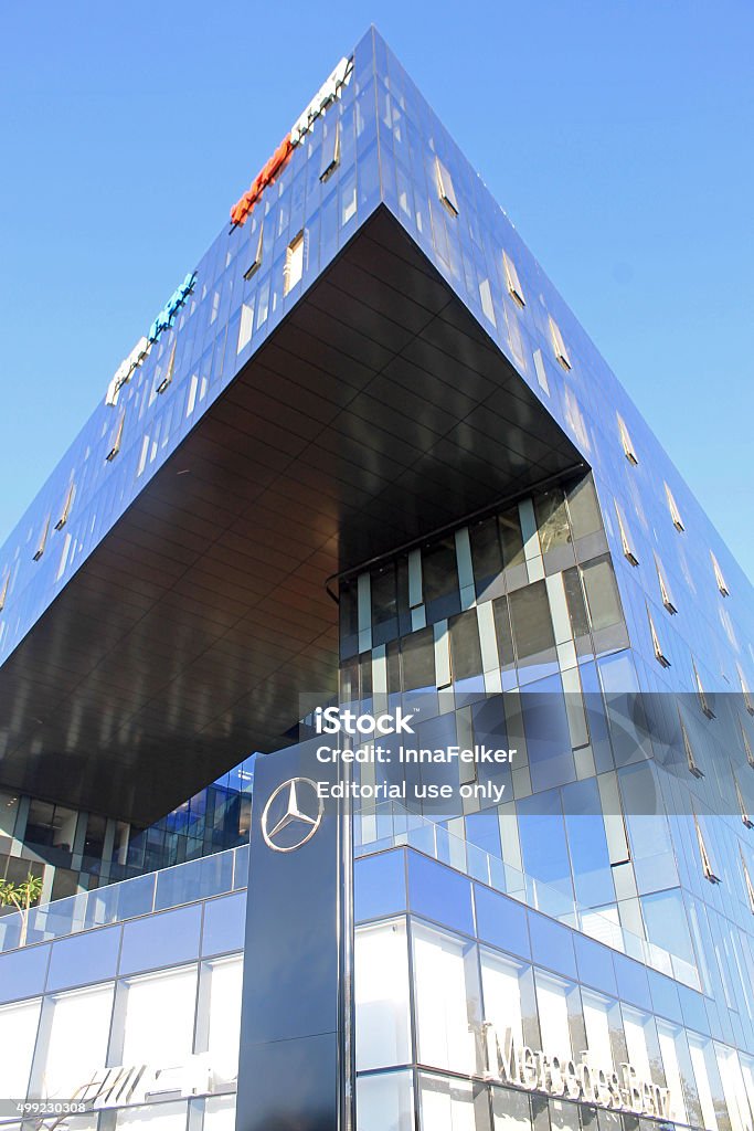 modern futuristic architecture building and Mersedes Benz salon, Herzliya, Israel - August 31, 2015: Urban landscape with modern futuristic architecture building and Mersedes Benz salon, Herzliya, Israel. Vertical image 2015 Stock Photo