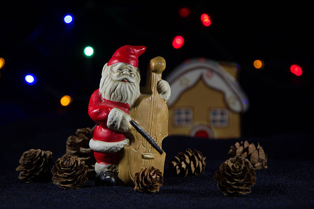 Decorative Santa Claus playing cello. Christmas music.