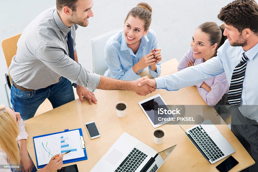 Business people shaking hands across table 2015 Stock Photo