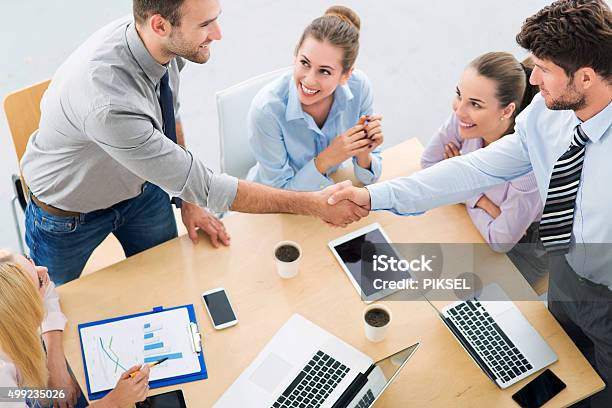 Business People Shaking Hands Across Table Stock Photo - Download Image Now - 2015, Adult, Adults Only