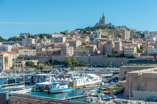 Old port of Marseille with the Cathedral Notre Dame de la Garde in the background.