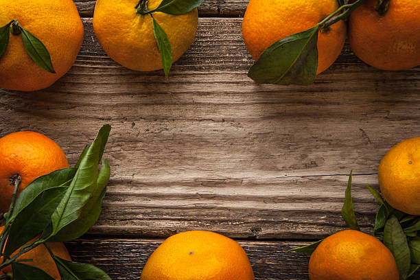 istock Frame of mandarins on the wooden table horizontal 499236744