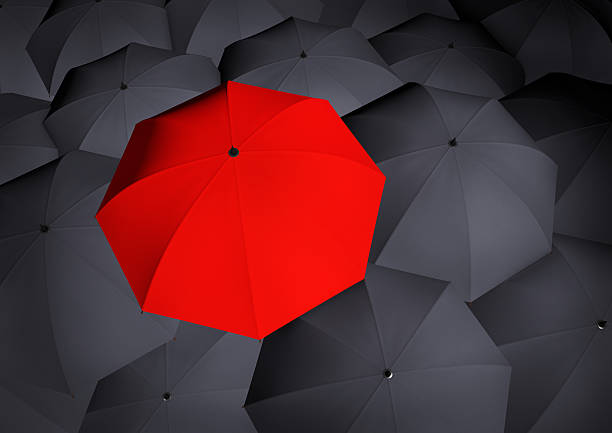 istock Top view on unique red umbrella among many dark ones. 499237222