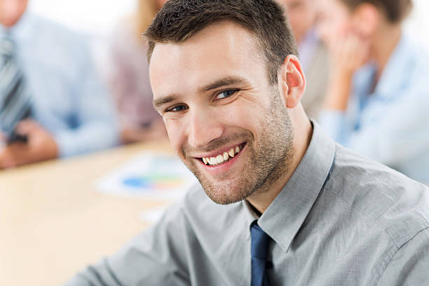 istock Businessman with coworkers in background 499237392